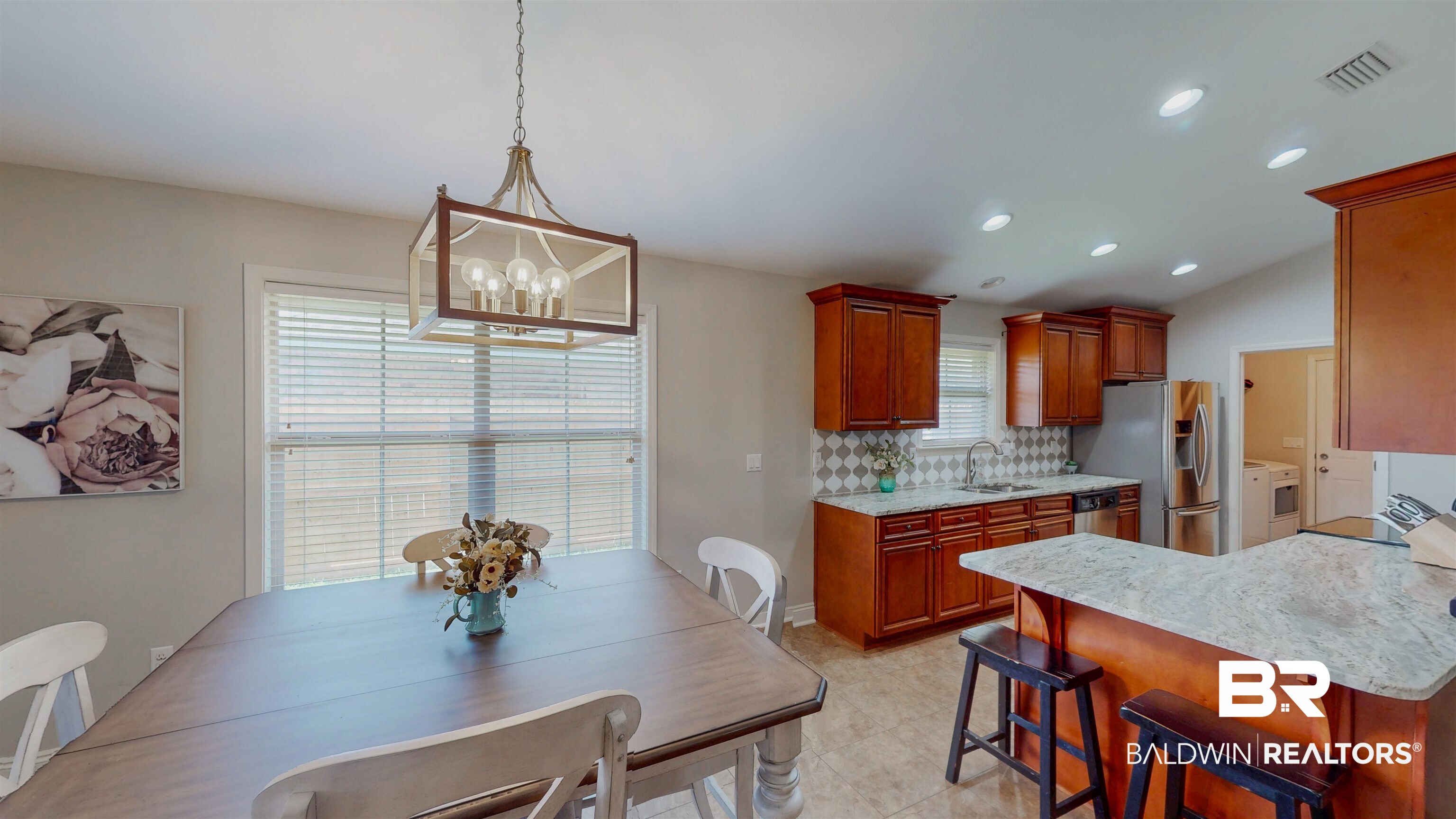 1704 Arcadia Drive Foley, AL 36535 - Photo 13 of 52 Kitchen with appliances with stainless steel finishes, backsplash, a kitchen bar, a chandelier, and decorative light fixtures