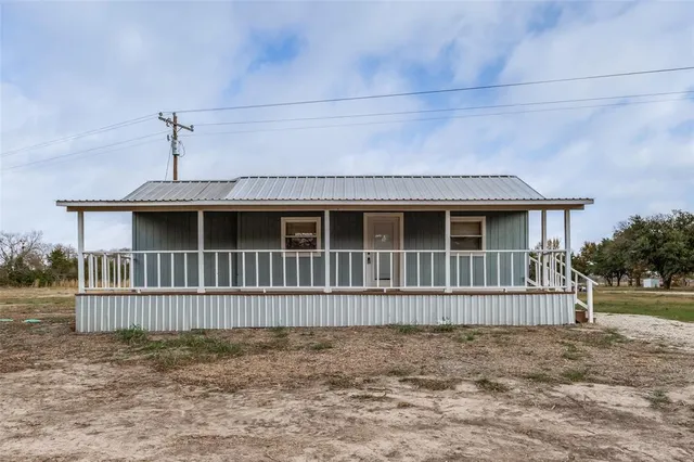 a front view of a house with wooden fence
