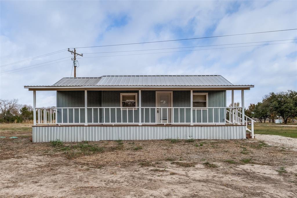1250 County Road 4120 Bonham, TX 75418 - Photo 1 of 27 a front view of a house with wooden fence
