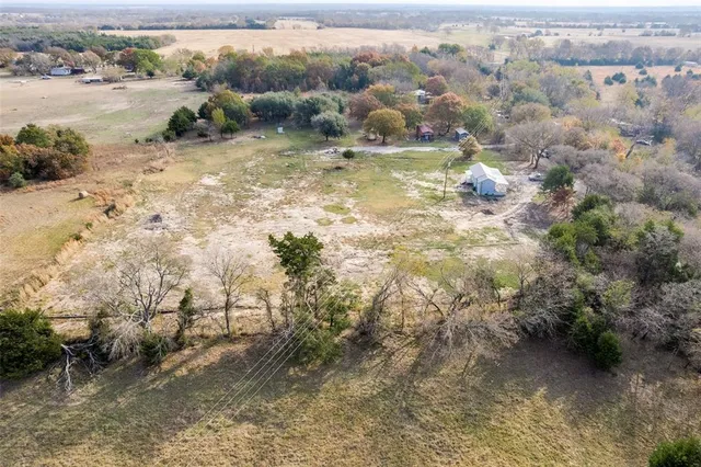 a room with wooden floors and brick walls