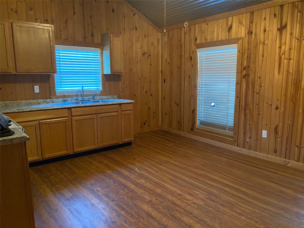 1250 County Road 4120 Bonham, TX 75418 - Photo 14 of 27 a room with wooden floors and brick walls