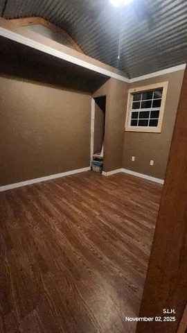 a view of a room with wooden floor