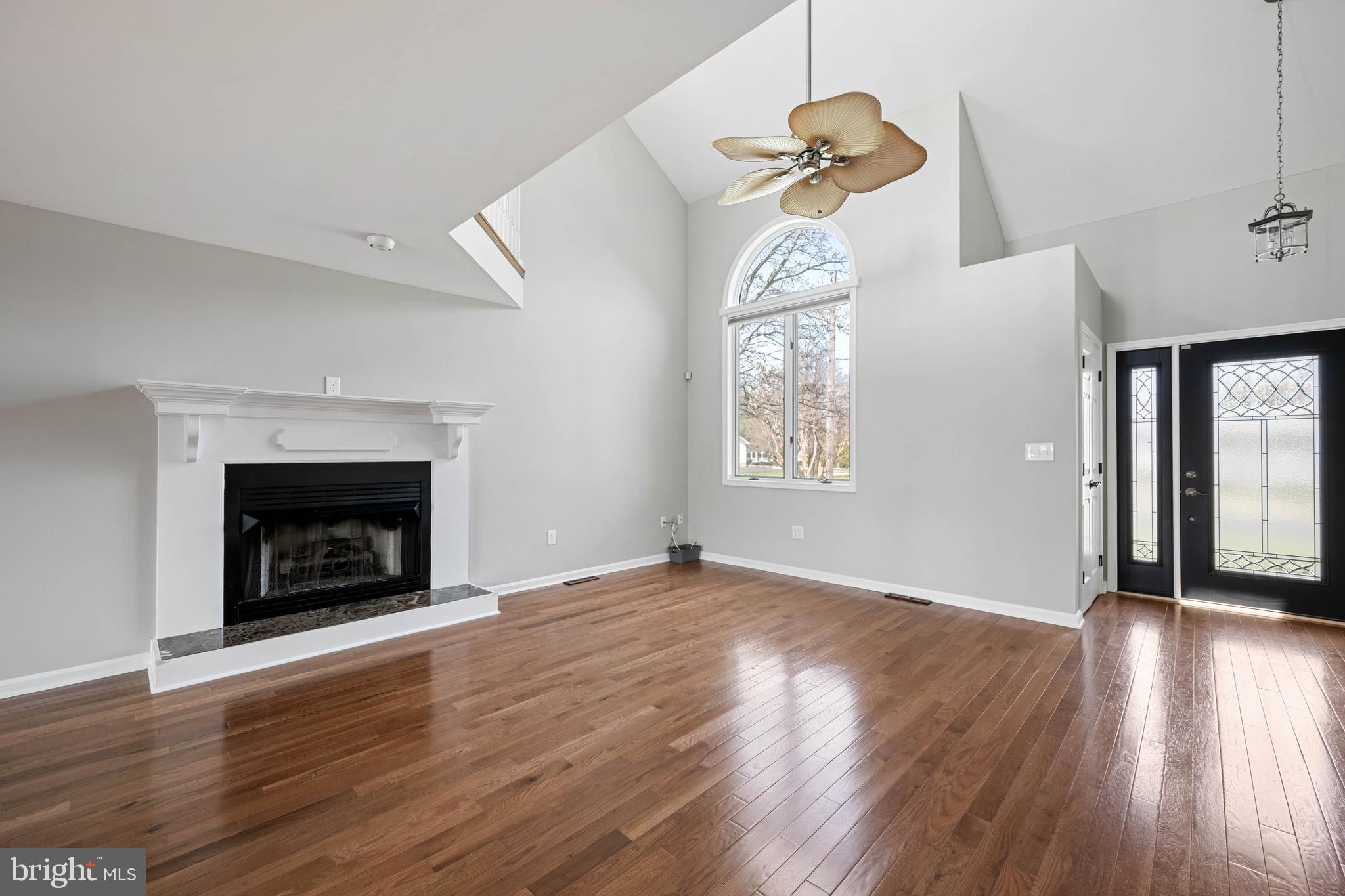11 Arnell Road Rehoboth Beach, DE 19971 - Photo 11 of 46 an empty room with wooden floor fireplace and windows