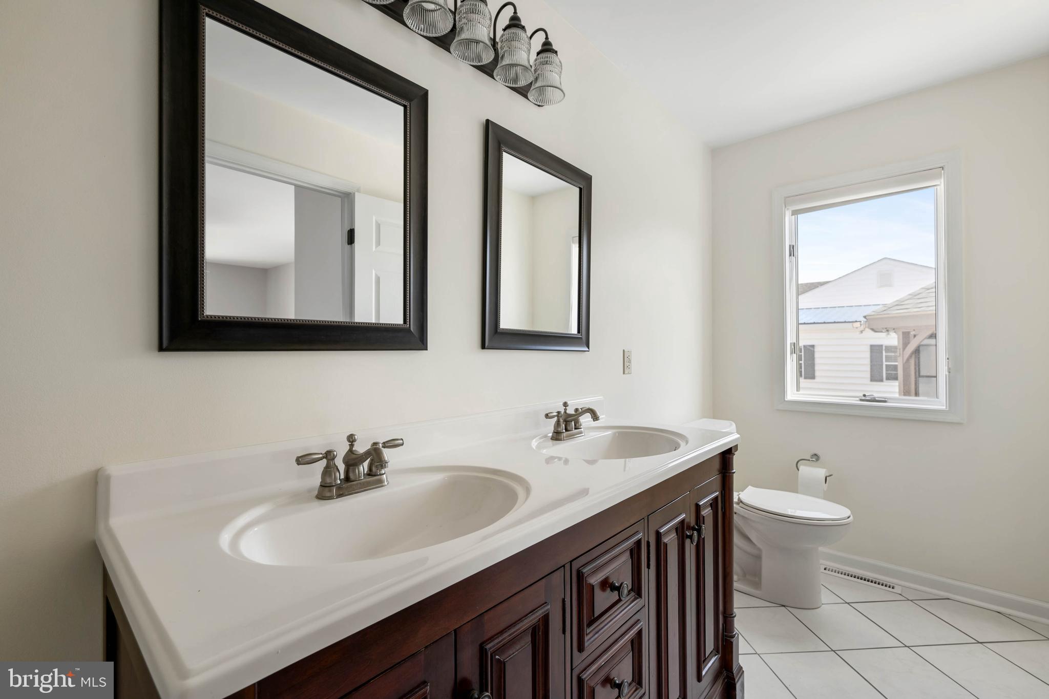 11 Arnell Road Rehoboth Beach, DE 19971 - Photo 15 of 46 a bathroom with 2 sink and a toilet