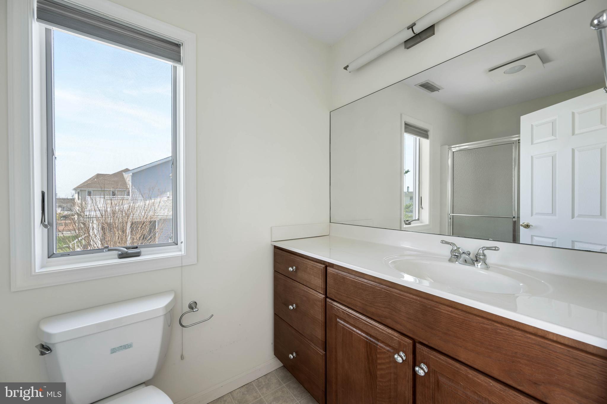 11 Arnell Road Rehoboth Beach, DE 19971 - Photo 23 of 46 a bathroom with a granite countertop sink mirror vanity and toilet