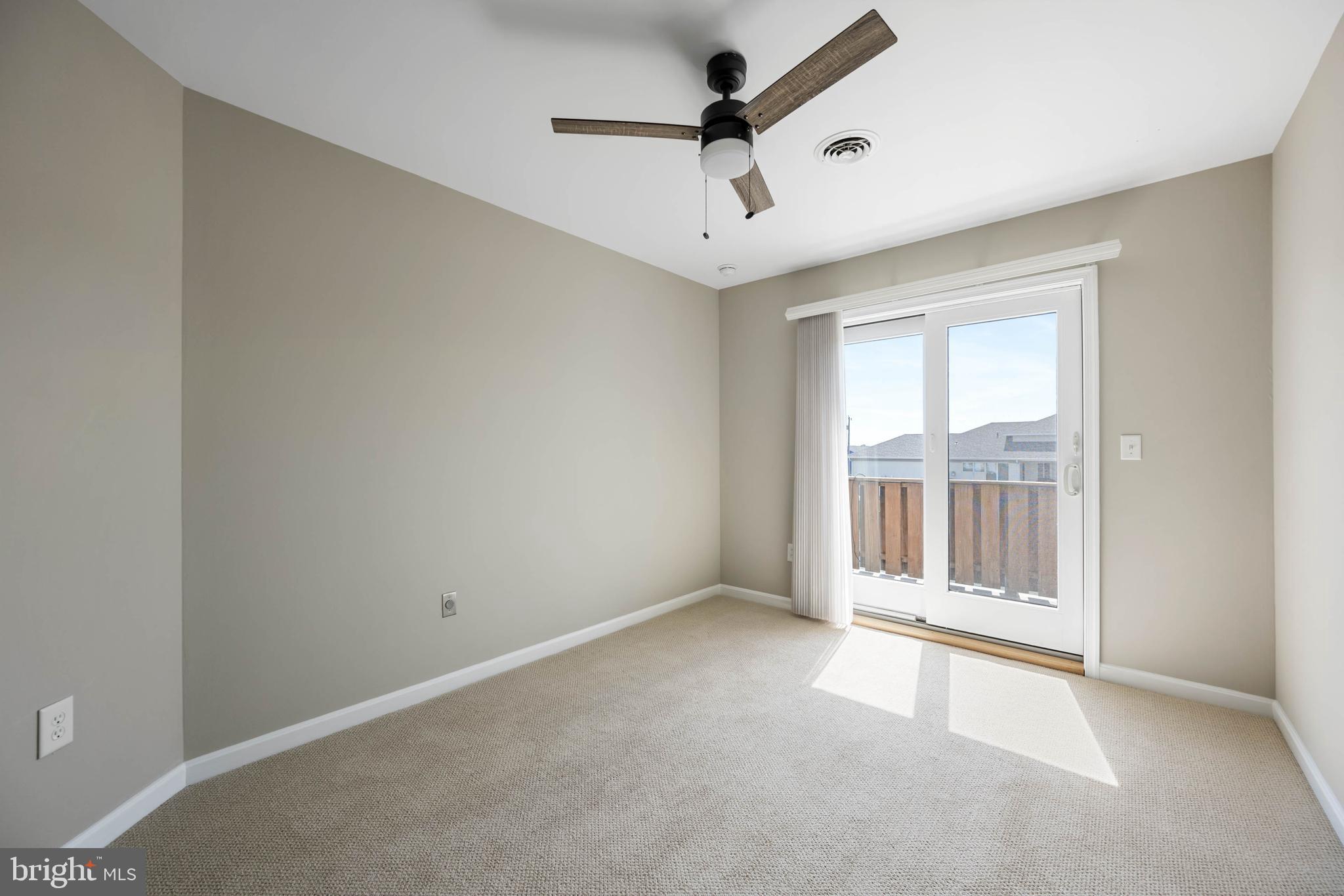 11 Arnell Road Rehoboth Beach, DE 19971 - Photo 24 of 46 an empty room with a ceiling fan and windows