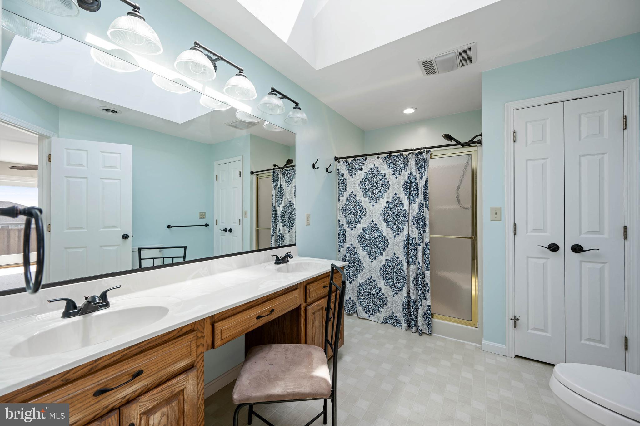 11 Arnell Road Rehoboth Beach, DE 19971 - Photo 27 of 46 a bathroom with a double vanity sink mirror and shower