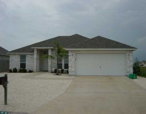 16002 Cuttysark Street Corpus Christi, TX 78418 - Photo 1 of 7 a front view of house with yard and trees in the background