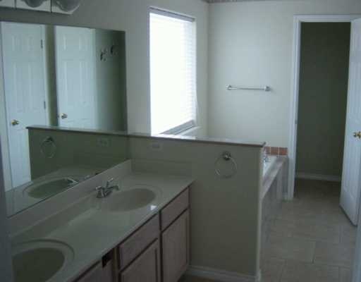 16002 Cuttysark Street Corpus Christi, TX 78418 - Photo 6 of 7 a bathroom with a sink and a mirror