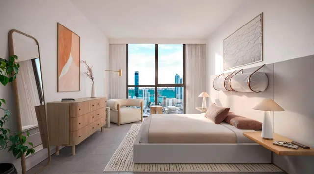 a bedroom with two beds and large windows