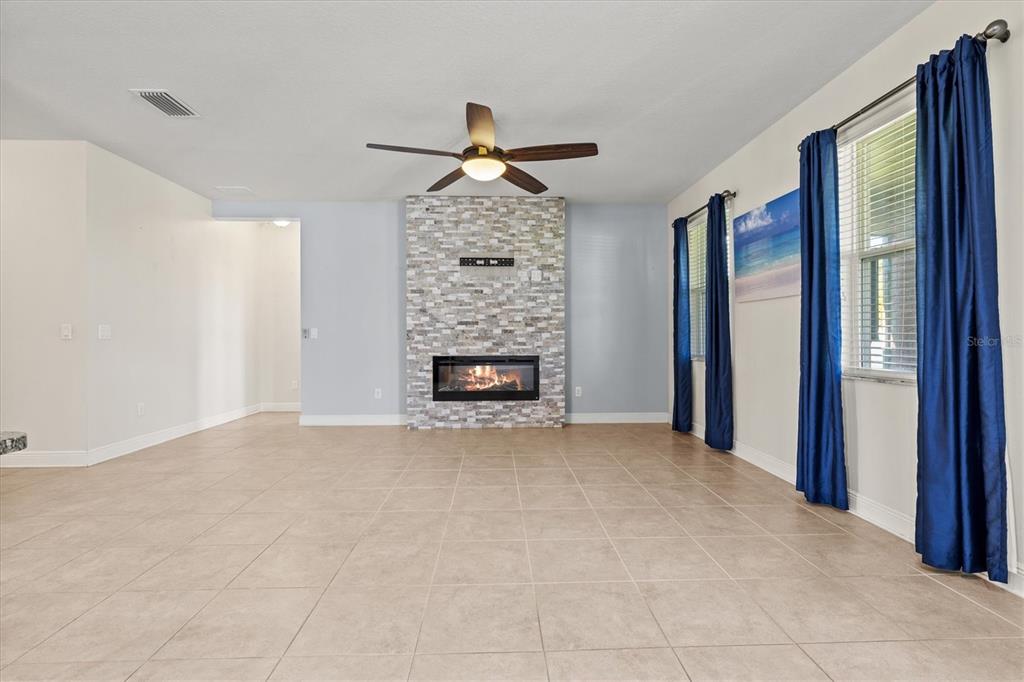7923 111th Terrace East Parrish, FL 34219 - Photo 18 of 80 a view of an empty room with a fireplace