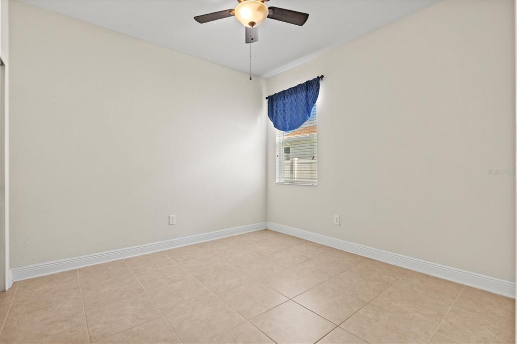 7923 111th Terrace East Parrish, FL 34219 - Photo 31 of 80 an empty room with a chandelier fan