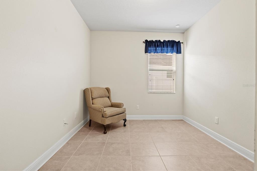 7923 111th Terrace East Parrish, FL 34219 - Photo 33 of 80 a room with a chair and a window