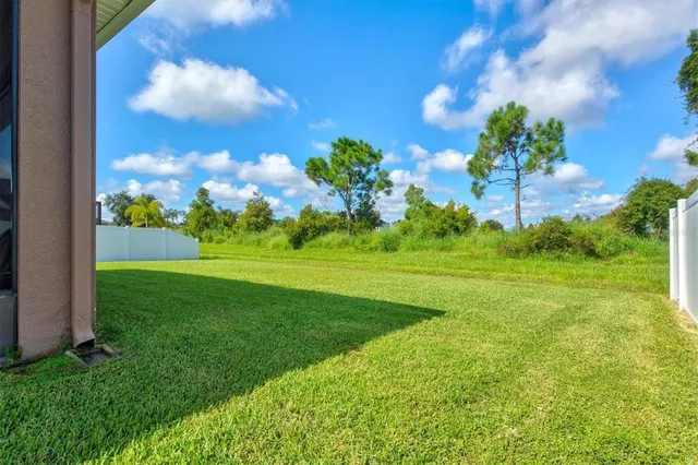 an aerial view of a house with a garden and lake view