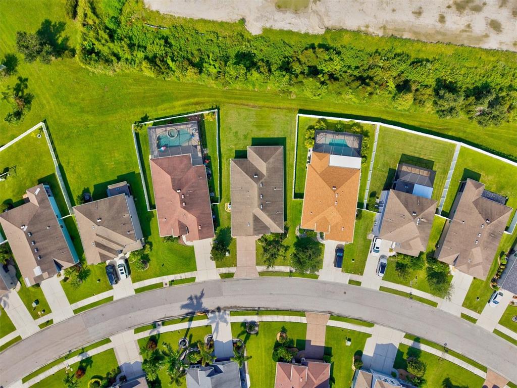 7923 111th Terrace East Parrish, FL 34219 - Photo 47 of 80 an aerial view of a house with a garden and swimming pool