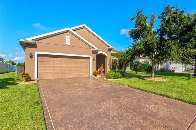 a front view of house with yard and green space