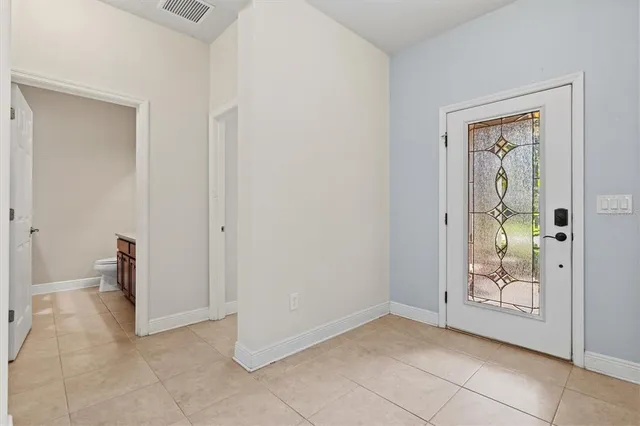 a view of an entryway and a hallway to rooms