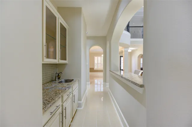 an empty room with staircase and a floor to ceiling window