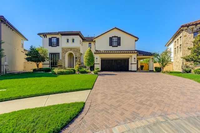 a view of a white house with a big yard and large trees