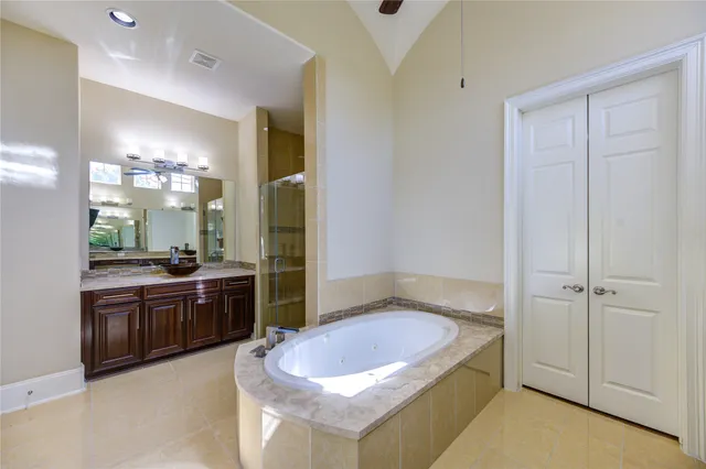 a bathroom with a sink a toilet a mirror and shower