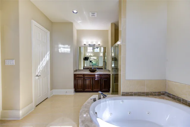a bathroom with a granite countertop sink a toilet a mirror and shower