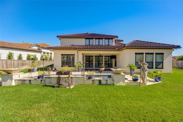 an aerial view of a house with a yard and potted plants
