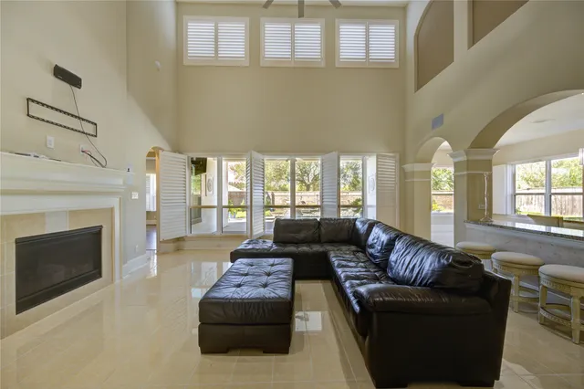 a living room with furniture a fireplace and a chandelier