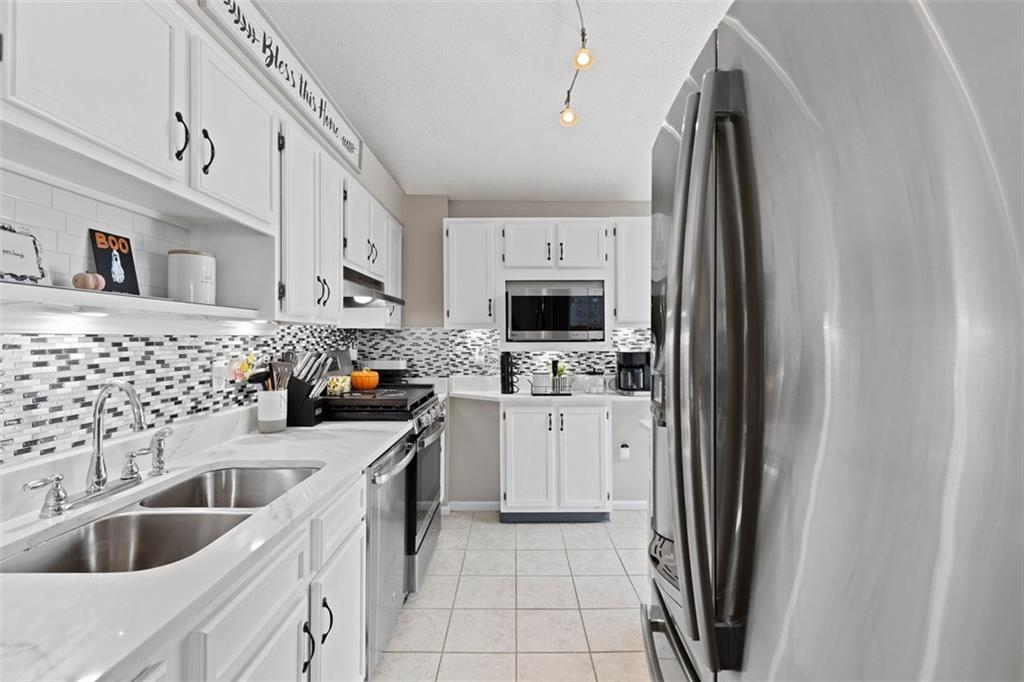 5079 Windriver Drive McKees Rocks, PA 15136 - Photo 14 of 50 a kitchen with stainless steel appliances a refrigerator sink and microwave