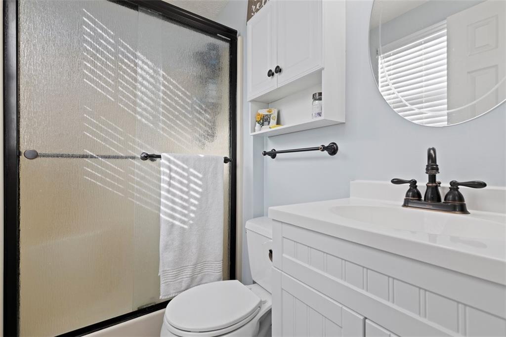5079 Windriver Drive McKees Rocks, PA 15136 - Photo 21 of 50 a bathroom with a sink a toilet a shower and a mirror