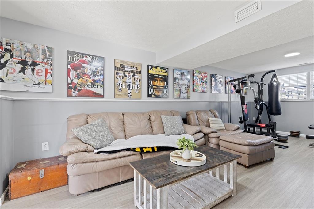 5079 Windriver Drive McKees Rocks, PA 15136 - Photo 31 of 50 a living room with furniture and painting on the wall