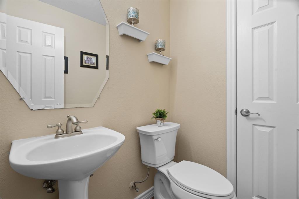 2703 Pottery Trail Corinth, TX 76210 - Photo 13 of 40 a bathroom with a sink toilet and a mirror