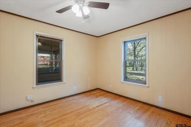 an empty room with windows and closet