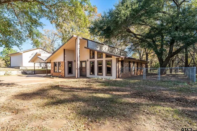 a view of large white house with a outdoor space
