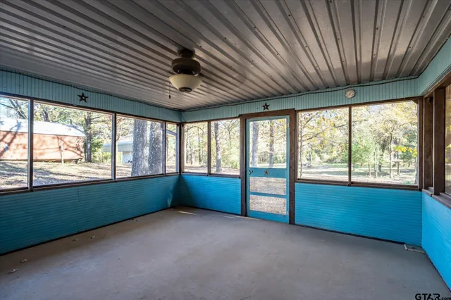 an empty room with window and furniture