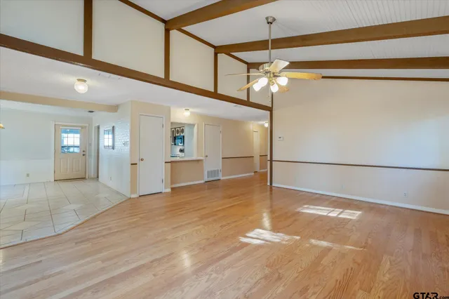 a view of empty room with wooden floor