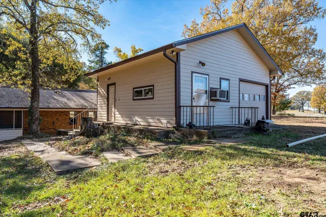a backyard of a house with yard and outdoor seating