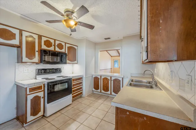 a kitchen with stainless steel appliances granite countertop a stove and a sink