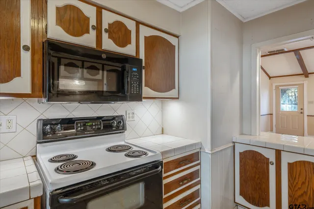 a stove top oven sitting inside of a kitchen