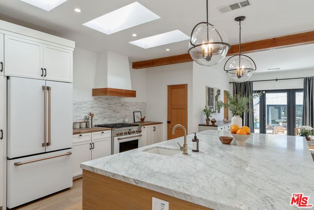 a kitchen with stainless steel appliances white cabinets and a stove