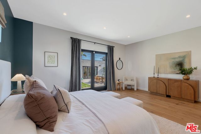 a bedroom with a bed and a mirror