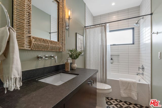 a view of a chair and table in backyard of house