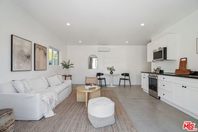 a view of a house with sitting area and garden