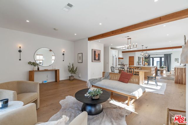 a living room with furniture a window and a ceiling fan
