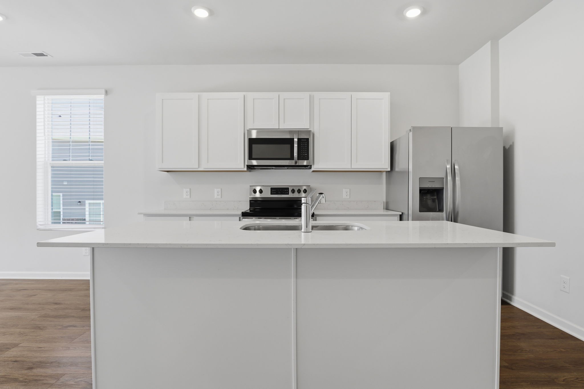 473 Alcott Way Spring Hill Spring Hill, TN 37174 - Photo 6 of 24 a kitchen with stainless steel appliances a stove a sink a refrigerator white cabinets and a microwave