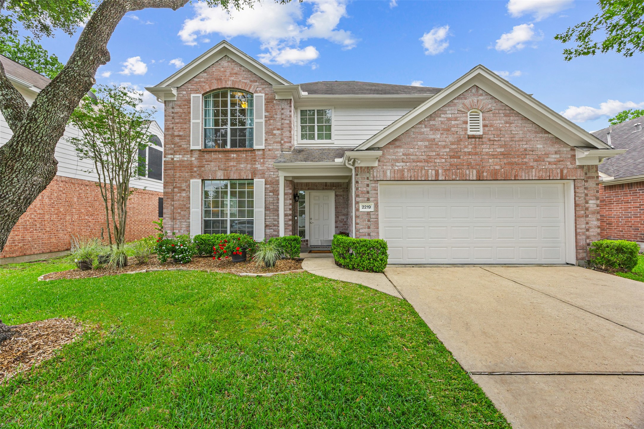 2219 Louetta Brook Lane Spring, TX 77388 - Photo 3 of 34 Charming two-story brick home with great curb appeal, featuring a spacious two-car garage, manicured landscaping, and a welcoming covered entry.
