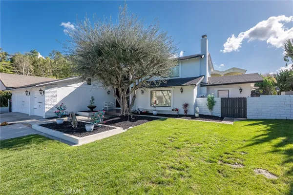 a view of a house with backyard and sitting area