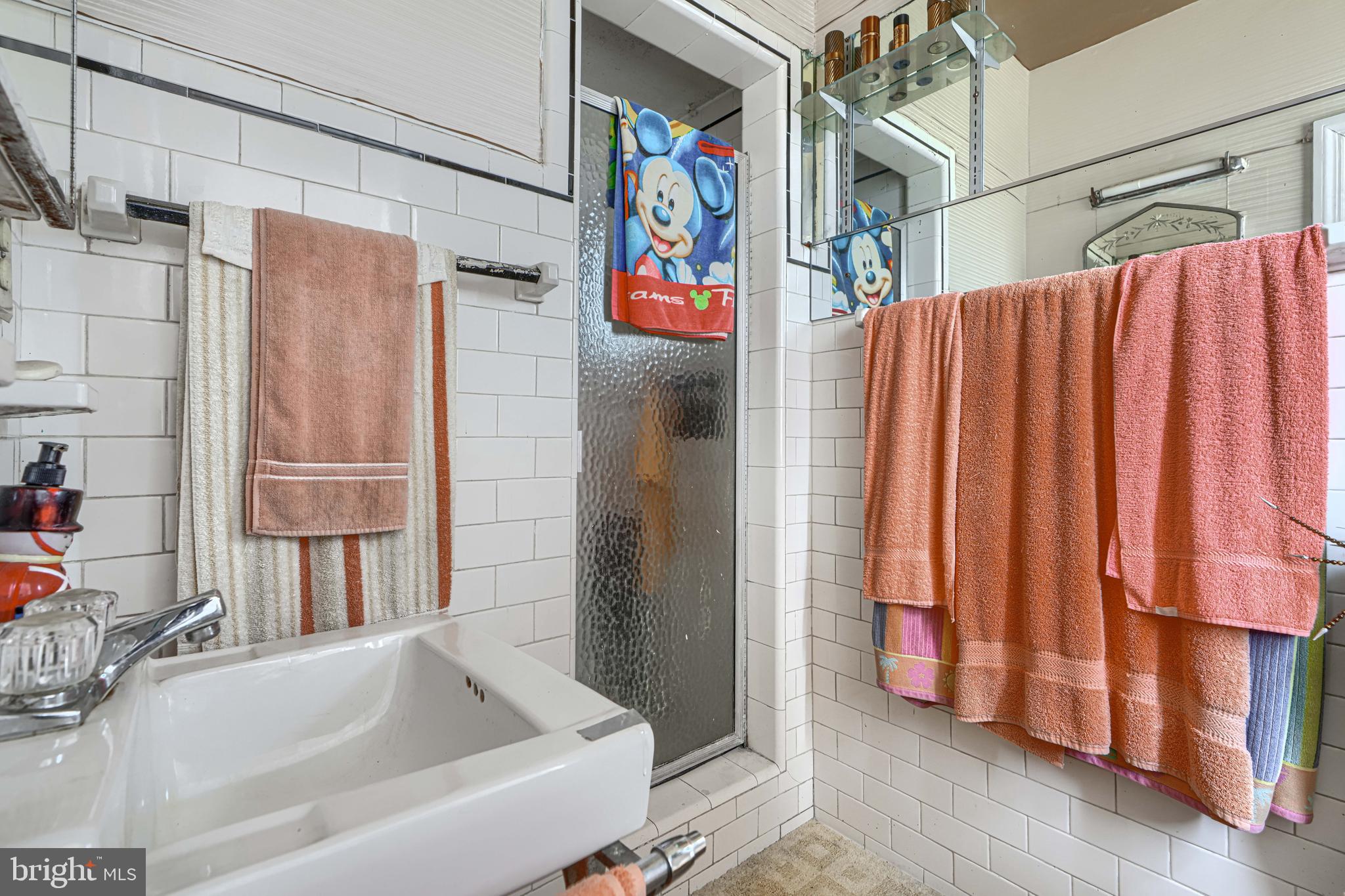 3212 Dorchester Road Baltimore, MD 21215 - Photo 22 of 45 a bathroom with a bathtub and a shower