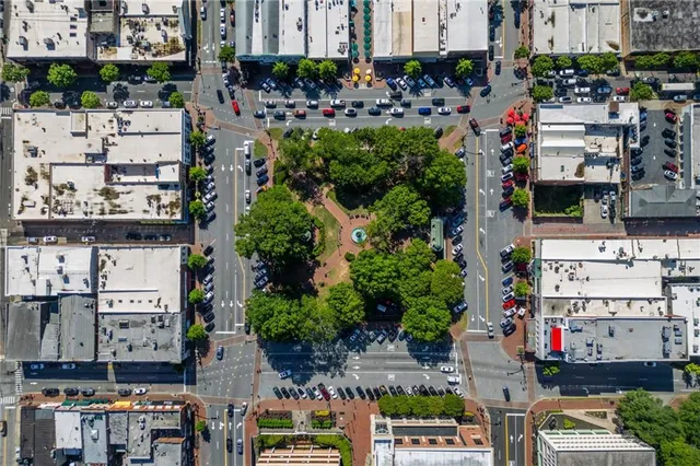 a park view with fountain plants and trees