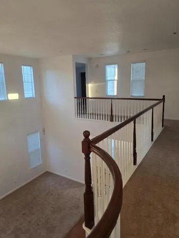 a view of a hallway with stairs