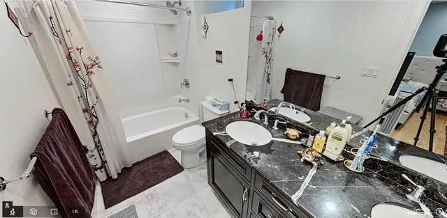 a bathroom with a sink a mirror a toilet and a bathtub